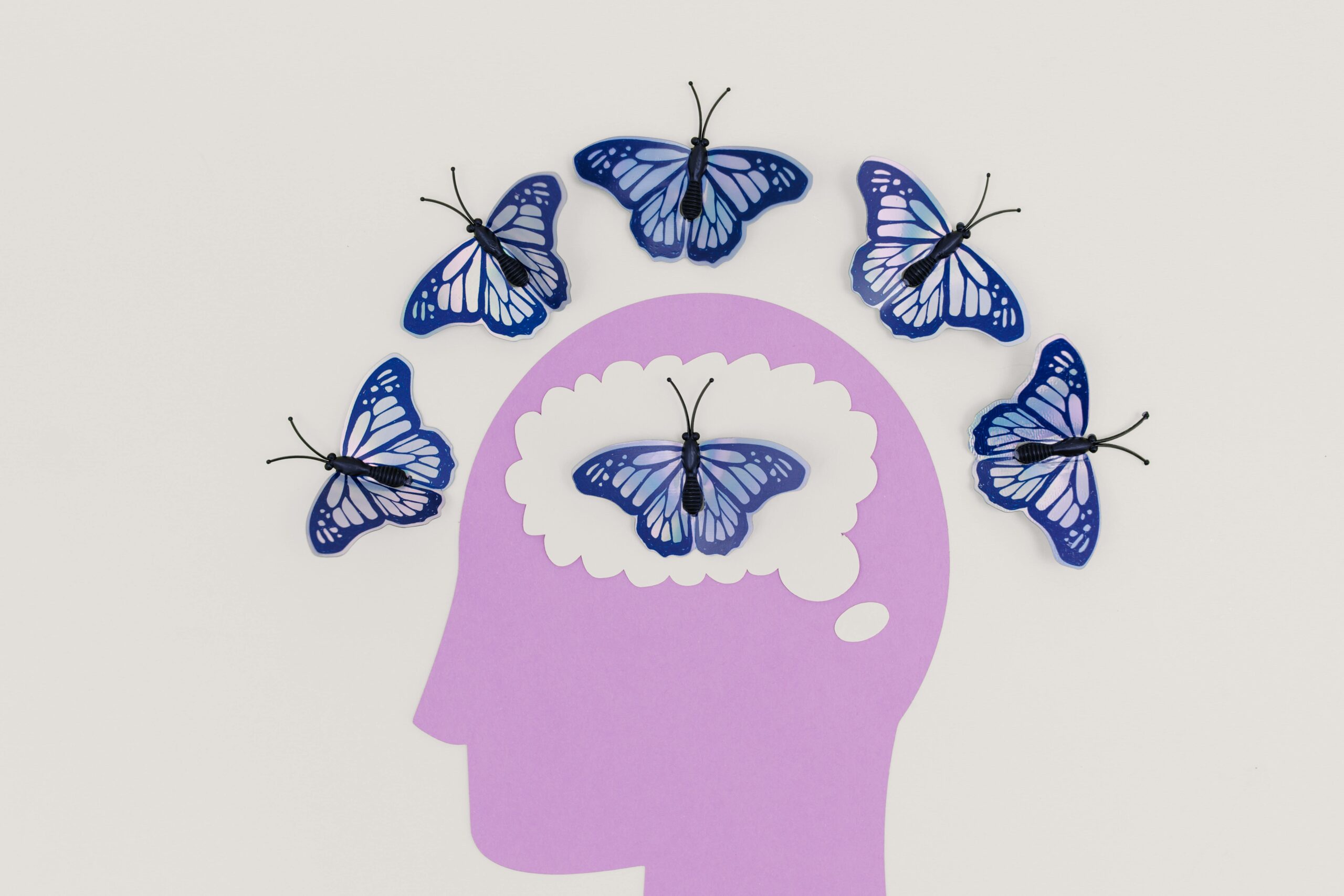 The Surprising Truth About Daydreams and Reality in Relationships Creative illustration of butterflies representing thoughts over a brain silhouette.